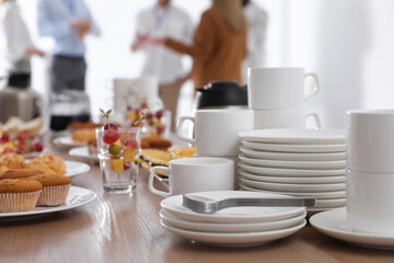 Dishware and different delicious snacks on table indoors. Coffee break