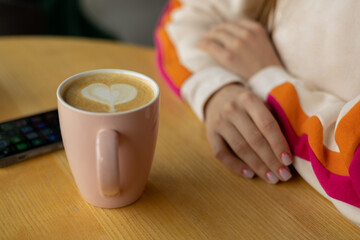 a girl drink coffee in a cafe