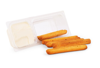 lager beer, piece of a smoked hard cheese, stick of smoked processed cheese and slices of the same smoked cheeses on a saucer on a light background