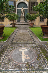 stone path and garden with statue in the background in Italy 