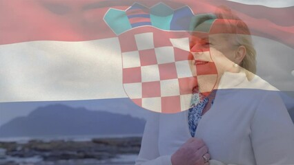 Animation of flag of croatia over happy senior caucasian woman on beach - Powered by Adobe