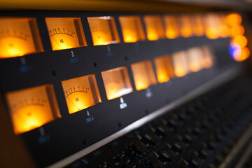 Close up of audio workstation and sound equipment in professional recording studio, copy space