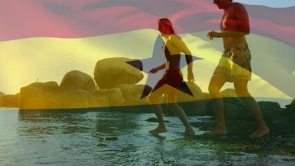 Animation of flag of ghana over diverse group of friends at beach - Powered by Adobe