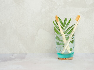 Natural bamboo toothbrushes in a glass jar. dental care, plastic free concept. Copy space for text