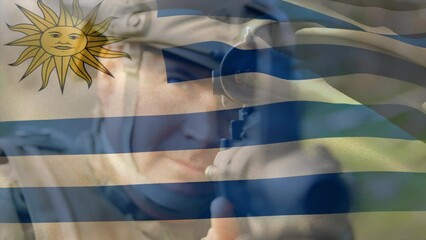 Animation of flag of uruguay over caucasian male soldier with weapon - Powered by Adobe