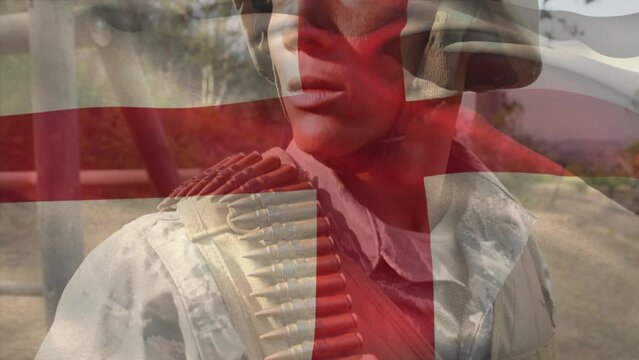 Animation of flag of england over biracial male soldier with weapon