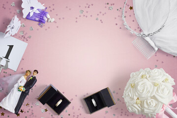 Wedding accessories on a pink background with copy space