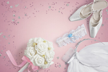 Wedding accessories on a pink background with copy space