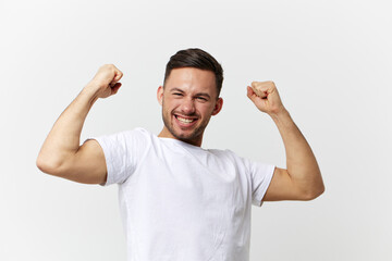 Overjoyed funny happy tanned handsome man in basic t-shirt shows muscles posing isolated on over white studio background. Copy space Banner Mockup. People emotions Lifestyle concept