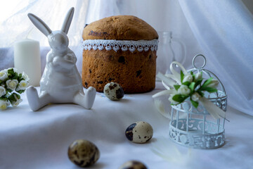 Easter cakes, hare,cell, quail eggs on a light surface
