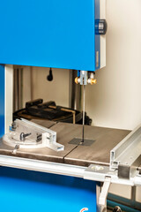Band saw with adjustable guide rails for precise material processing.