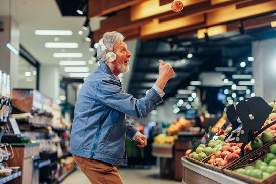 Mature man dancing in the supermarket