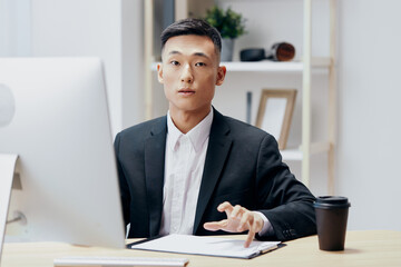 businessmen works at the computer glass of coffee emotion office technologies