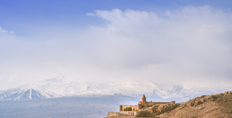 Panoramic banner of Khor virap monastery against snowy mountain of Ararat. Banner with place for text