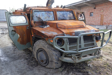 Fototapeta premium Military armored vehicles blown up and burned down on the street. Russian military vehicle 