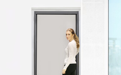 Fototapeta premium Beautiful woman opening the door of her home.