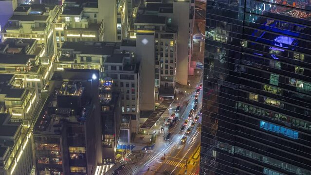 Hotels and office buildings in financial district in Dubai aerial night timelapse