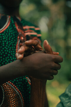 Photo of a young hand holding and elderly hand