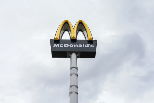 Prague, Czech Republic, Czechia - April 7, 2022: McDonalds. Outdoor ad, advertising and promotion on the pylon. Fast food and restaurant chain. Cloudy sky and copy space.