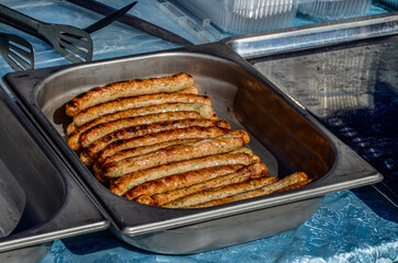 Grilling sausages on barbecue grill.