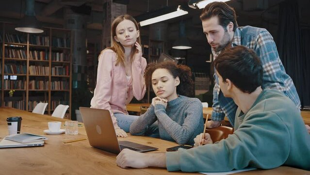 Troubled millennial people working on urgent computer project in team