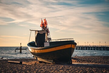 Beautiful morning view at the Polish seaside in Gdynia. Ship on a sandy beach in the morning.