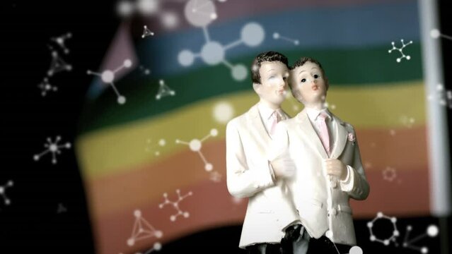 Animation of wedding figurine over colorful background