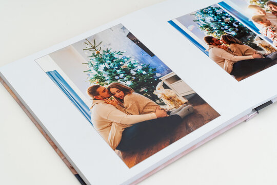 a book with new year photos of big family at home on a white background