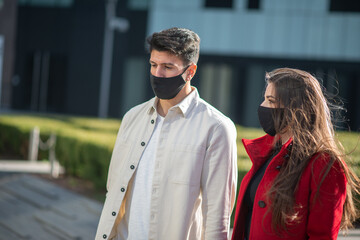 Couple walking in a city during covid or coronavirus pandemic