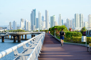 joggers on the pedestrian walkway of the marine viaduct in Panama City Panama