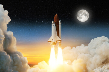 Spaceship lift off. Space shuttle with smoke and blast takes off into space on a background of a sunset with a full moon and stars in the sky. Elements of this image furnished by NASA.