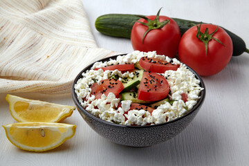 Vegetarian salad of cucumbers, tomatoes with curd cheese and black cumin seeds