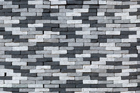 Background Brick Wall Of Uneven Bricks Of Black White And Gray Color