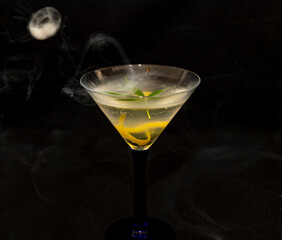 Cannabis infused martini cocktail on black background