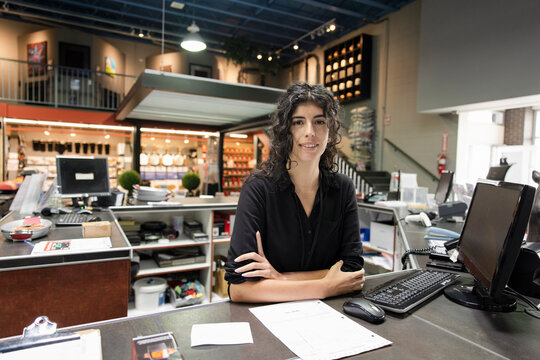 Portrait of cheerful worker at service counter