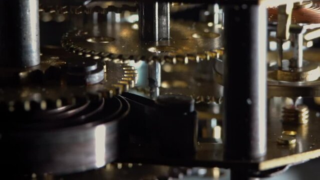 Macro video of the primitive clockwork mechanism of an old desktop alarm clock