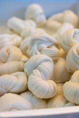 White soft braid cheese on market display