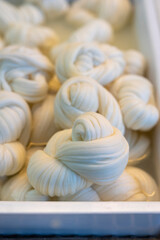 White soft braid cheese on market display