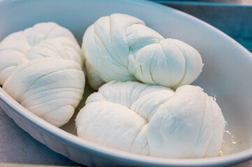 White soft braid cheese on market display