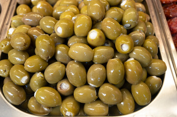 Green fresh olives close up on market, food background