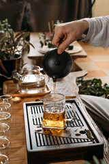 Traditional tea ceremony - pouring chinese oolong in glass cup