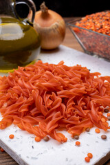 Vegan gluten free and vegetarian food, dried spiral pasta made from orange lentils legumes