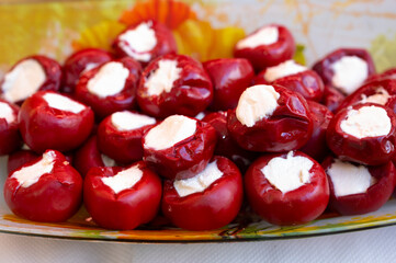 Mediterranean food, sweet red paprika pepper stuffed with soft white cheese