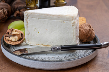 Delice de Bourgogne French cow's milk cheese from Burgundy region of France served with grapes, wine and walnuts