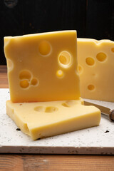 Swiss cheese collection, yellow emmentaler cheese with round holes