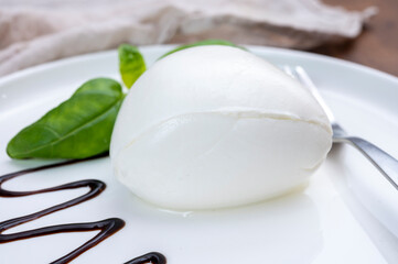 Tasing of fresh italian cheese mozzarella di buffalo with Balsamic vinegar from Modena