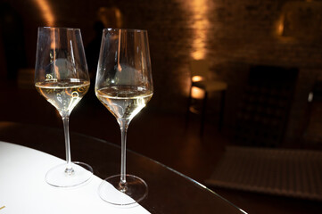 Tasting of brut champagne sparkling wine produced by traditional method in underground caves