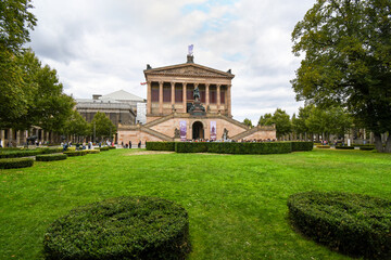 Tourists visit the National Gallery or Altes Nationalgalerie on an overcast day on Museum Island in Berlin Germany.