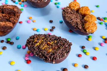 Chocolate filled easter egg, easter concept on blue background