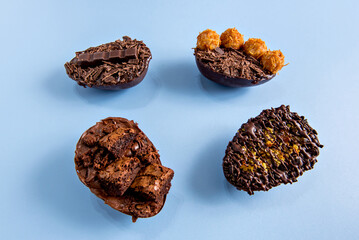 Chocolate filled easter eggs on blue background, easter concept.